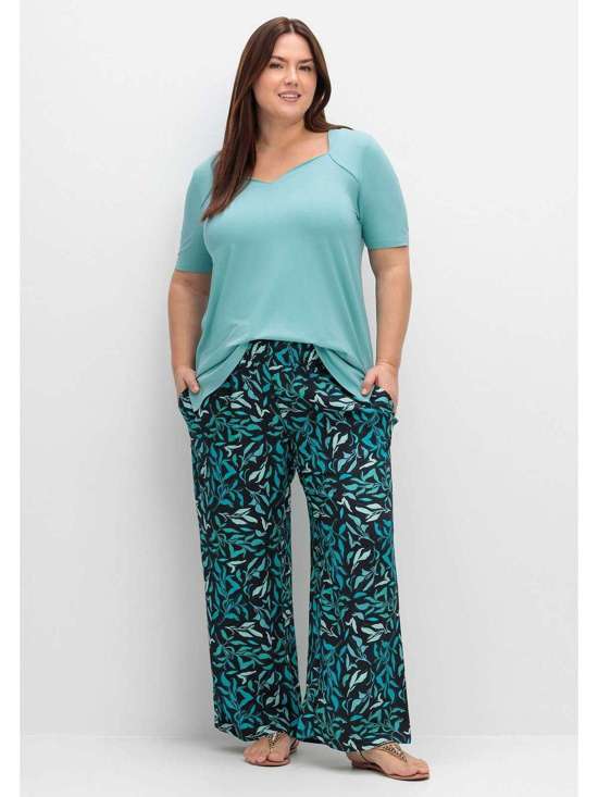 Брюки без застежки с присборенным поясом и принтом в виде листьев. Große Größen