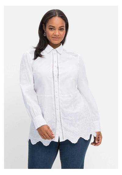 Блуза-рубашка с цветочной вышивкой и волнистым краем по краю.